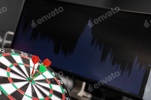 Preview: three Darts hit target against background of chart of stock market statistics