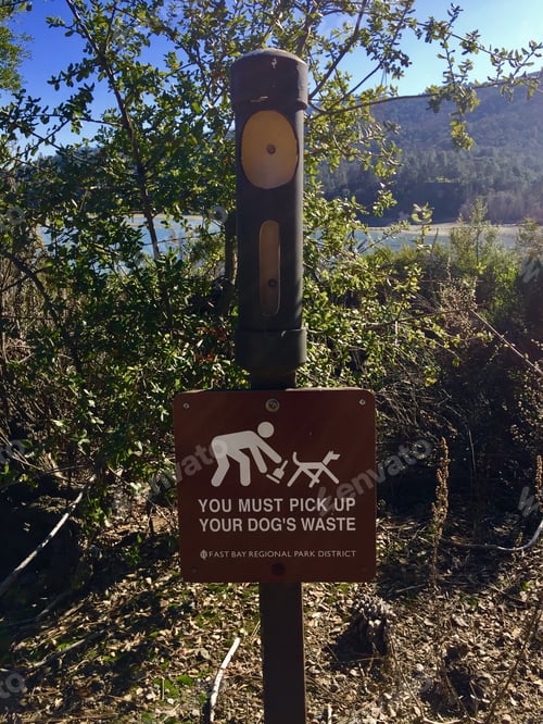 Preview: Sign in recreational area instructing people to pick up dog waste