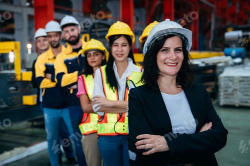 Preview: Portrait of industrial worker inspecting and check up machine at factory machines.