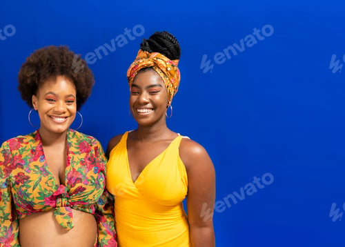 Preview: Portrait of two women against blue background.