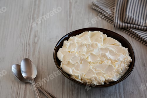 Preview: Organic White Mascarpone Cheese in a Bowl, side view. Copy space.