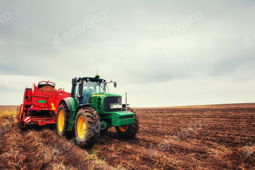 Preview: Tractor plowing farm field in preparation for spring planting