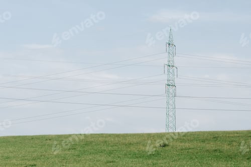 Preview: High-voltage steel pylon tower with electric lines on a rural green field