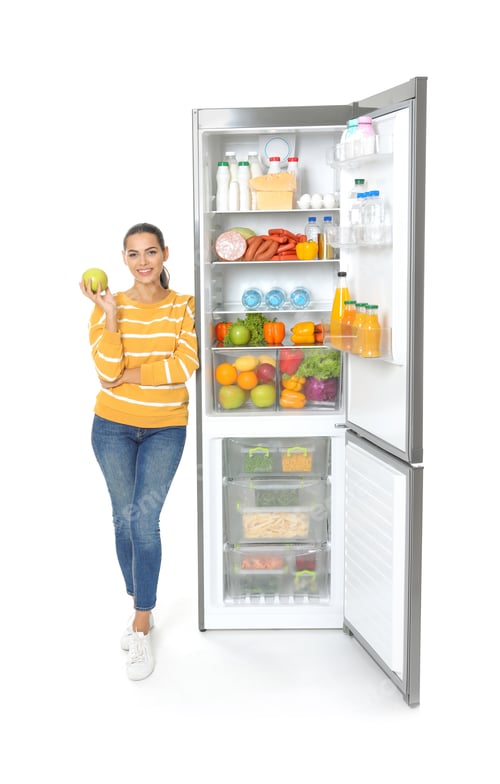 Preview: Young woman with apple near open refrigerator on white background