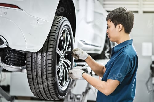Preview: Asian mechanic checking and repairing the car wheels in maintainance service center