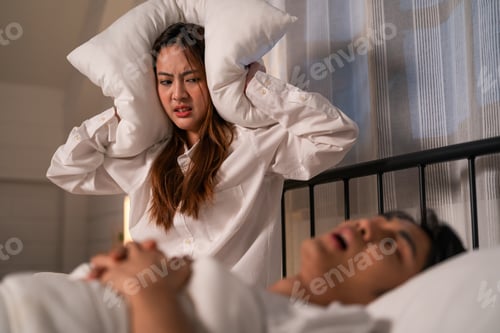 Preview: Asian woman feel frustrated from husband snoring while sleep at night.