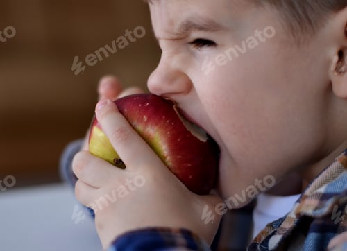 Preview: boy biting a red apple