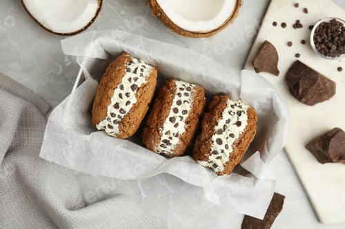 Preview: Sweet delicious ice cream cookie sandwiches served on table, flat lay