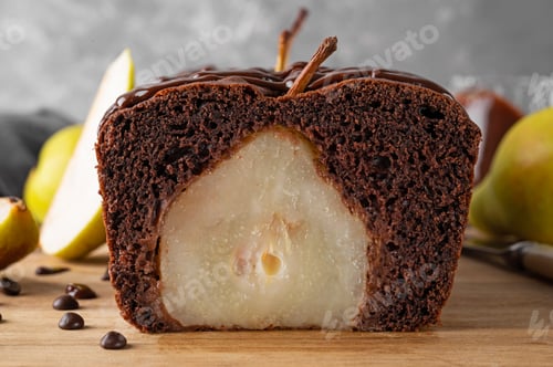 Preview: Chocolate pie or cake with whole pears and chocolate glaze on top on gray background.