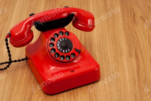 Preview: Old fashioned red painted retro telephone on wood with copy space