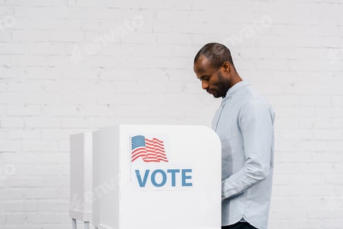 Preview: african american citizen voting near stand with vote lettering