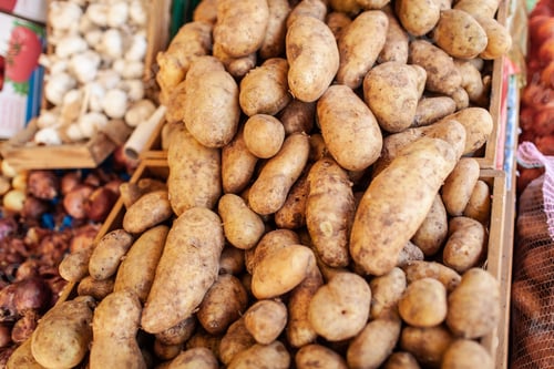 Preview: A closeup of potatoes in wooden boxes