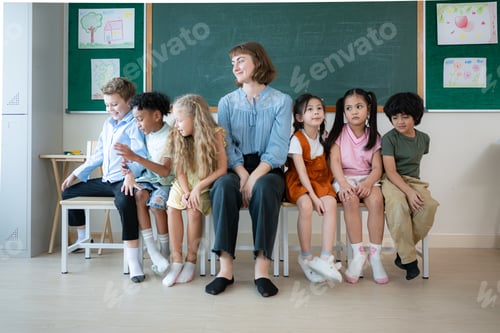 Preview: Portrait of a teacher and kids in a classroom where children have pleasure learning.