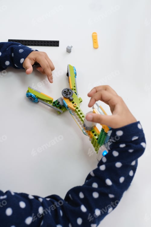 Preview: African American girl having fun with robot on STEM lesson