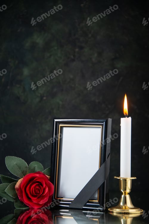 Preview: front view of burning candle with red flower on black background evil death funeral