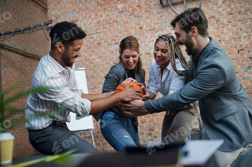 Preview: Group of cheerful young businesspeople playing basketball in office, taking a break concept