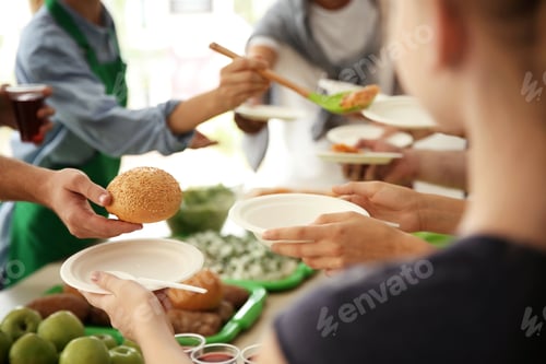 Preview: Volunteers serving food for poor people indoors