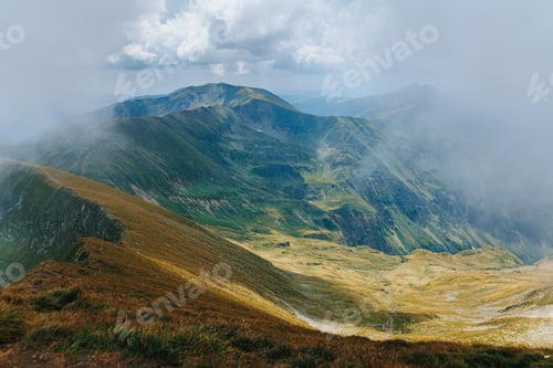 Preview: Aerial view of misty Carpathian mountain ridges and green valleys