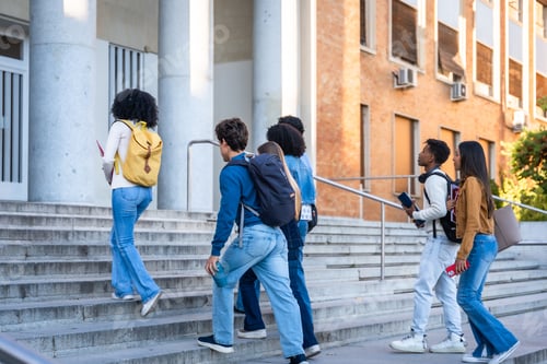 Preview: Diverse university students walking up stairs to class