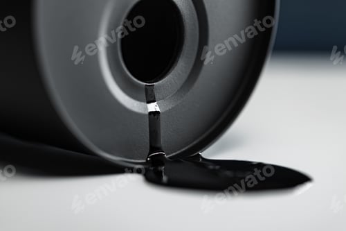 Preview: Oil industry concept. Spilled oil from a mini barrel on white background