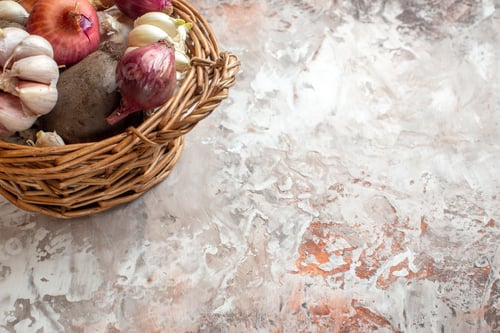Preview: front view basket with vegetables garlics onions and beet on light background color ripe salad