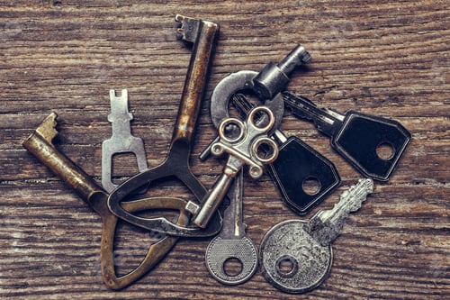 Preview: Old antique key and a set of vintage keys on a wooden background a flat top view, a concept of