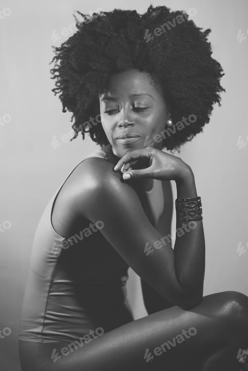 Preview: Black and white photograph of an African American model under neon illumination