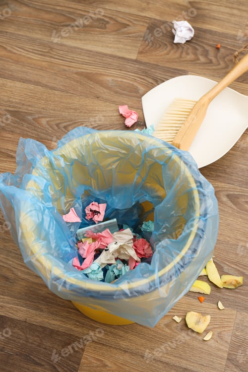 Preview: Garbage can with bag, rubbish and broom on wooden background