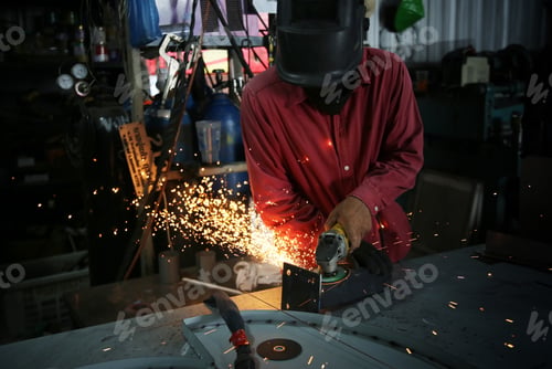 Preview: Welder used grinding stone on steel in factory with sparks, Welding process at the industrial worksh