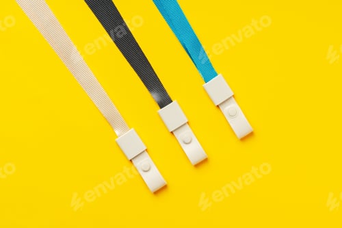 Preview: Badge strings on yellow background close up