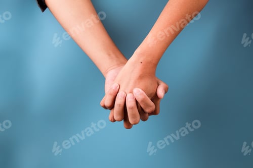 Preview: Close-up of Two Hands Clasped Together Showing Symbol Of Love, Support Or Togetherness