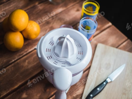 Preview: orange juice squeezer on a wooden surface close up