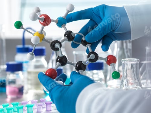 Preview: Scientist holding a molecular model in a laboratory