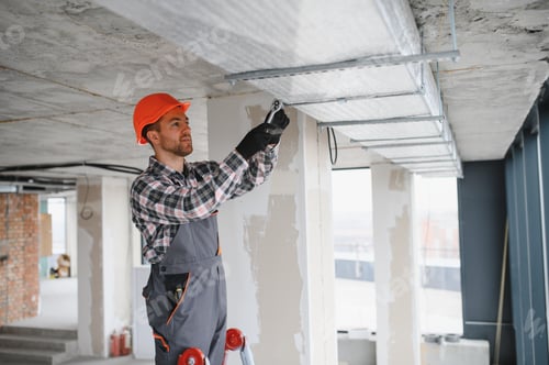 Preview: Construction worker installing ventilation system in building under construction