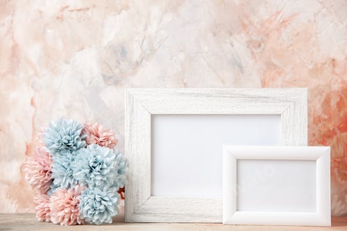 Preview: Front view of white small big empty wooden photo frames and flower on pastel colors background with