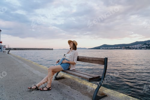 Preview: Pregnant woman relaxing near the sea