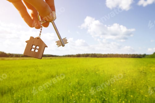 Preview: Wooden pendant of a house and key. Background of the sky and field