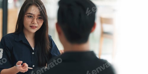 Preview: Young attractive asian woman with glasses during job interview