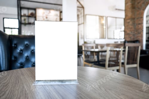 Preview: Blank screen mock up menu frame standing on wood table in coffee cafe and restaurant background