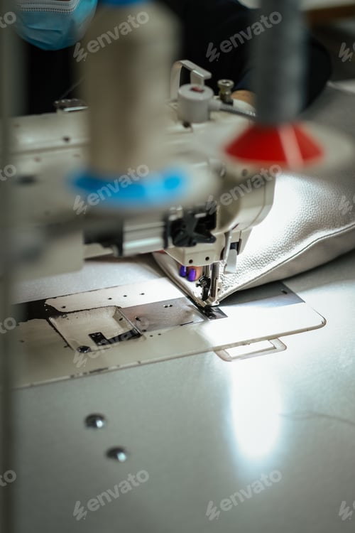 Preview: Vertical selective focus shot of a sewing machine