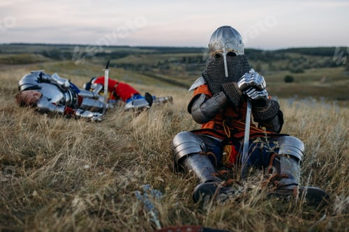 Preview: Medieval knight in armor sitting on the ground