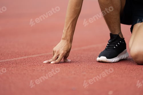 Preview: Athlete Preparing for a Run on Track - Emphasizing Fitness, Wellness, and the Joy of Jogging