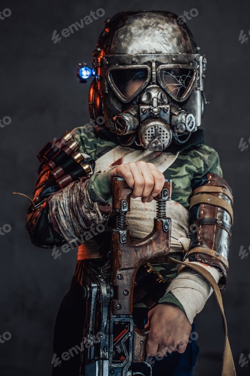 Preview: Armed with riffle little boy with gas mask in dark background