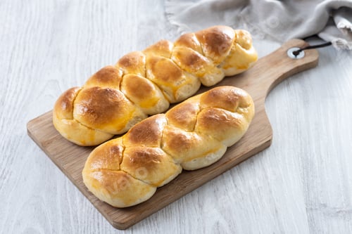 Preview: Traditional Easter braided bread. Tsoureki braid on white wooden table