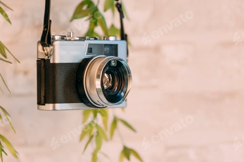 Preview: Old black camera hanging on the wall.