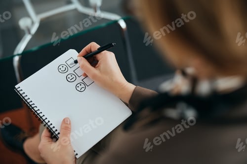 Preview: Close-up of therapist filling questionnaire while having counseling in her office.