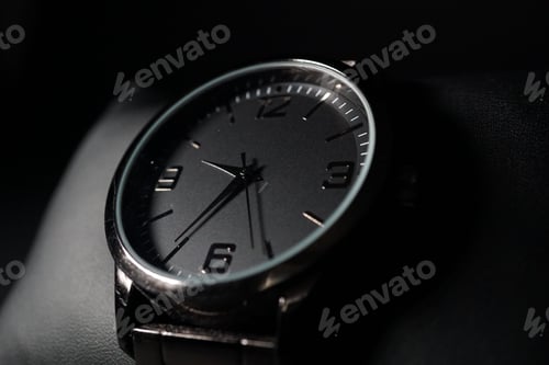 Preview: Elegant Dark Wristwatch in Shadowy Close-Up Still Life