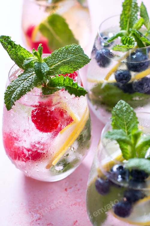 Preview: Raspberry, lemon and blackberry infused water in glasses on pink table