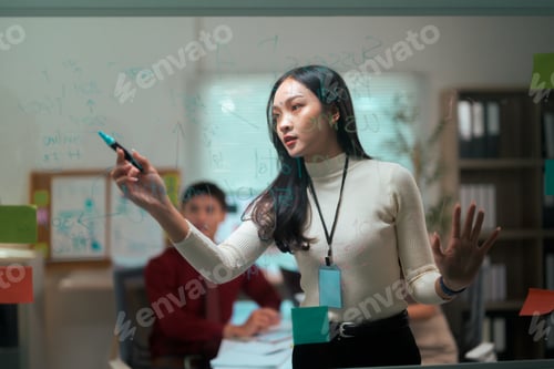 Preview: Young asian businesswoman presenting strategy during office meeting