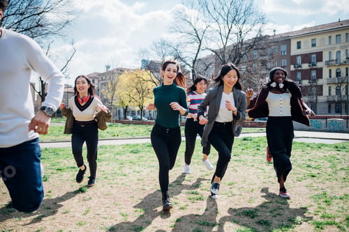 Preview: Young male and female adults running in park